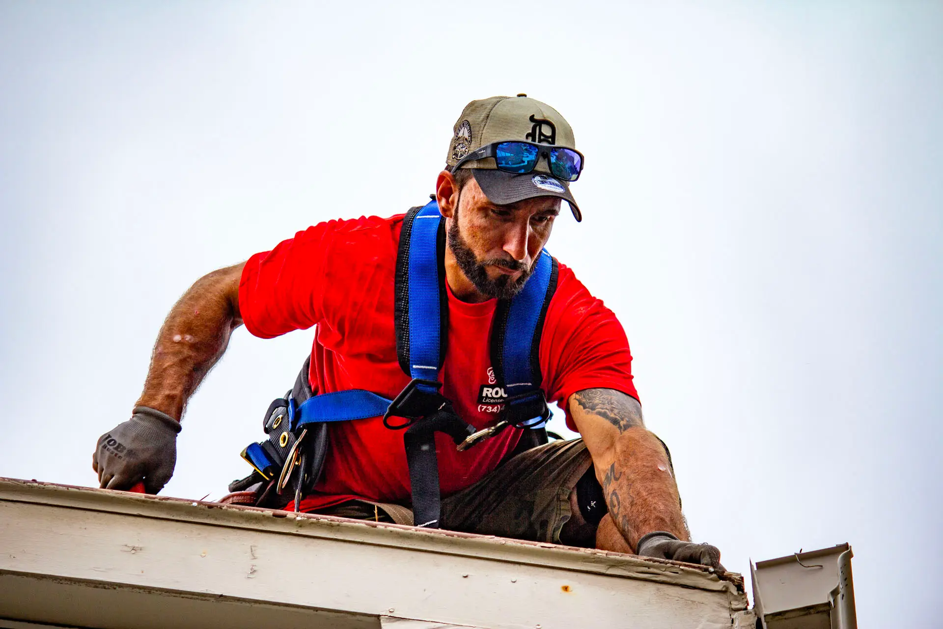 Billy's Roofing crew member inspecting roof damage in Metro Detroit.