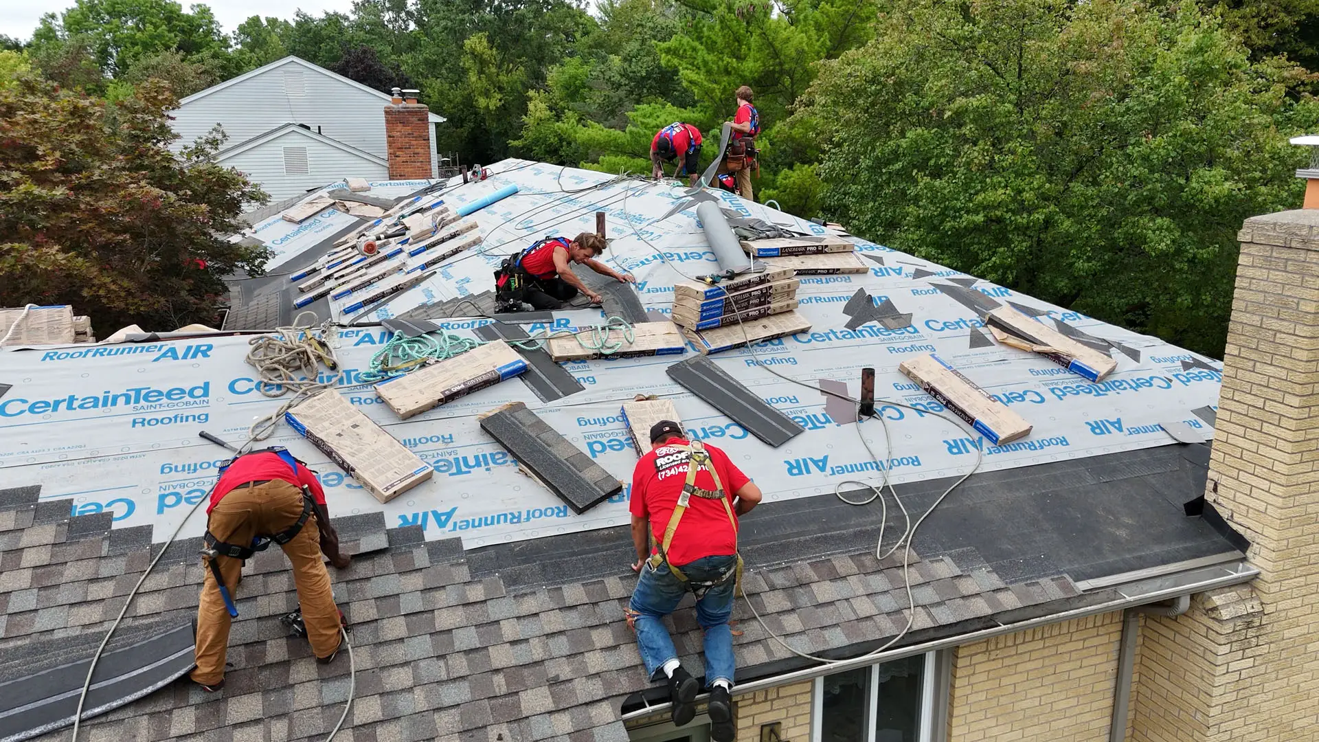 Billy's Roofing crew installing new residential roof.
