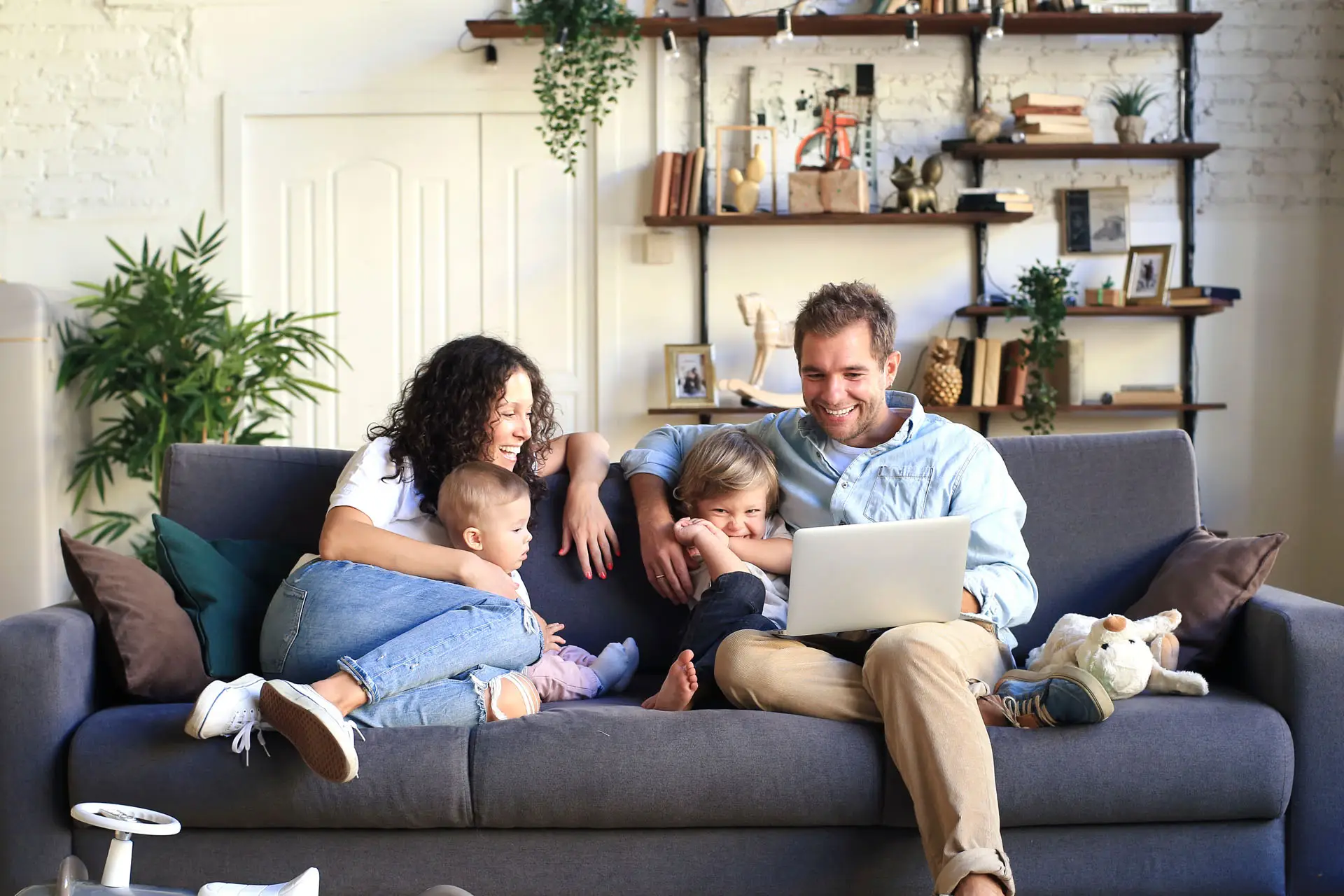Young happy family looking at laptop.