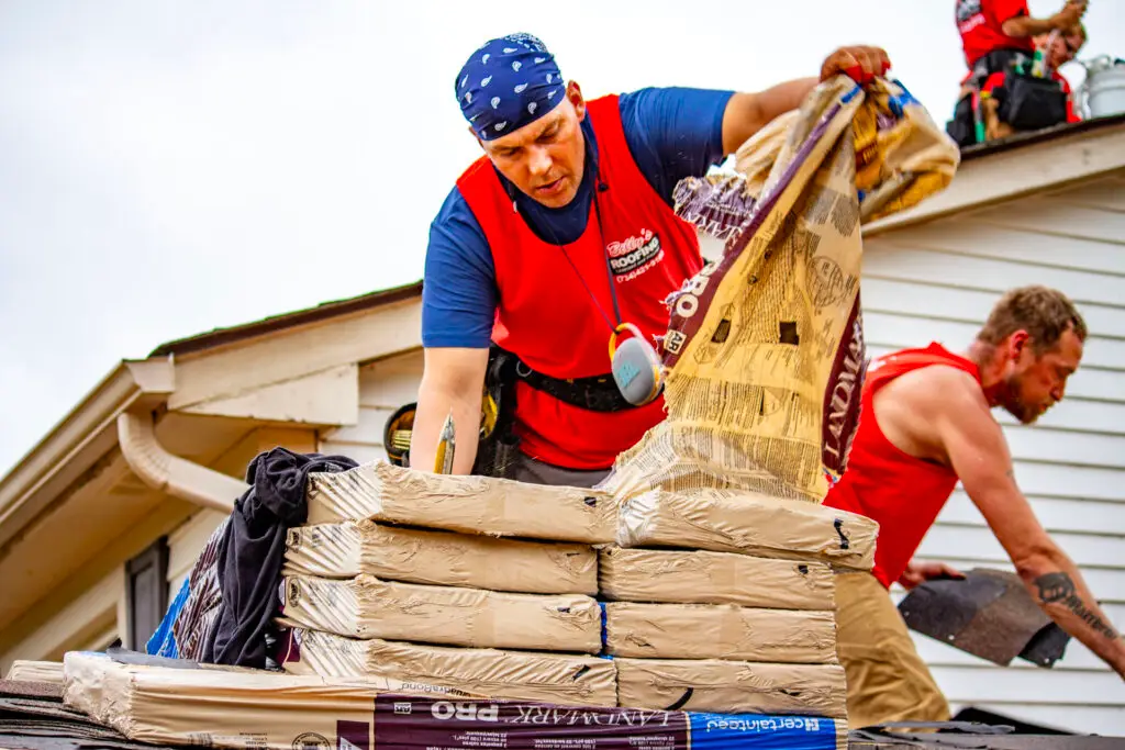 Billy's Roofing crew opening shingles during residential roof replacement in Metro Detroit.