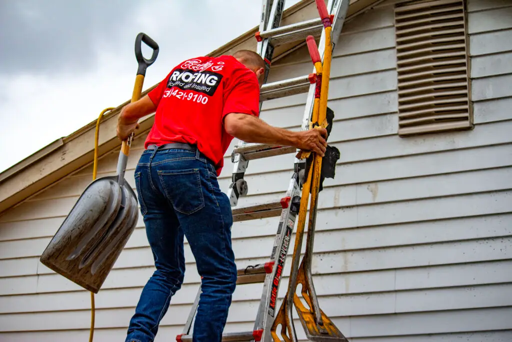 Billy's Roofing crew member climbing ladder during residential roof replacement in Metro Detroit.