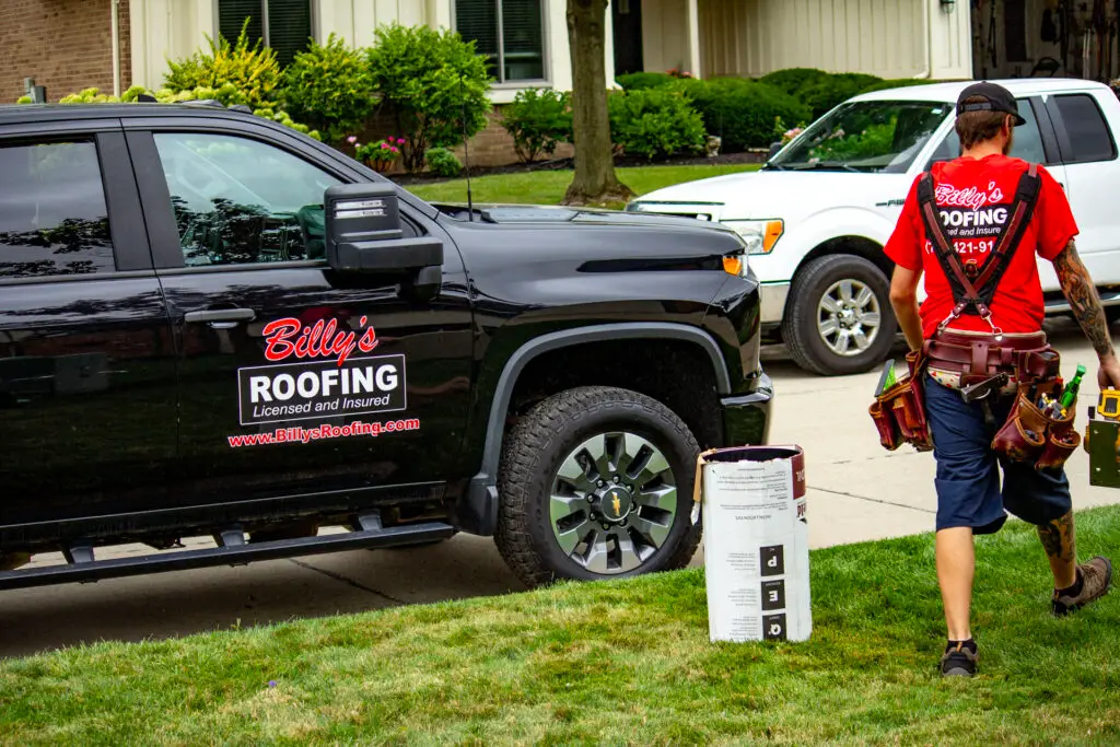 Billy's Roofing truck and crew member.